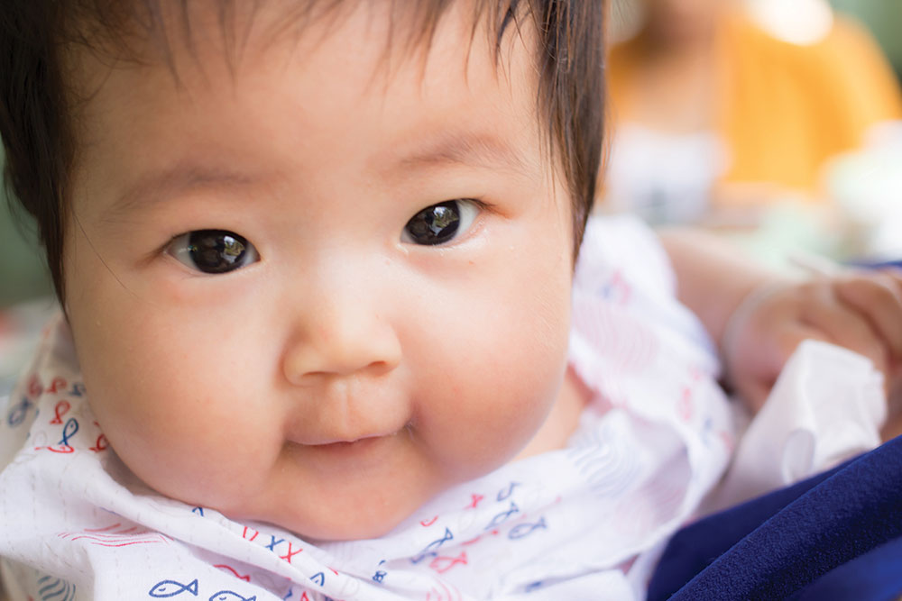 Beautiful young baby's face looking at camera