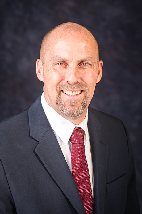 Photo of CEO Robert Allen in a suit and tie